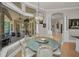 Dining room with decorative chandelier and outdoor fireplace view at 10808 Alico Pass, New Port Richey, FL 34655