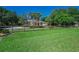 Beautiful home with mature trees and lawn is bordered by a decorative fence at 10808 Alico Pass, New Port Richey, FL 34655