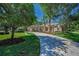 Beautiful home featuring a long driveway with manicured landscaping and mature trees at 10808 Alico Pass, New Port Richey, FL 34655