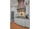 Gourmet kitchen features custom hood, stainless steel appliances, and granite countertops at 10808 Alico Pass, New Port Richey, FL 34655