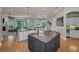 Open floor plan showcases kitchen with granite island and view to living area at 10808 Alico Pass, New Port Richey, FL 34655