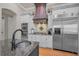 Bright kitchen featuring stainless appliances, custom cabinetry, and large center island at 10808 Alico Pass, New Port Richey, FL 34655