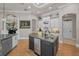 Kitchen featuring granite counters, custom cabinets, and stainless dishwasher on the island at 10808 Alico Pass, New Port Richey, FL 34655