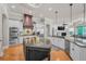 Open kitchen with a large center island, stainless appliances, and custom cabinetry at 10808 Alico Pass, New Port Richey, FL 34655
