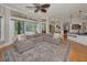 Spacious living room open to dining and kitchen areas with a comfy grey couch at 10808 Alico Pass, New Port Richey, FL 34655