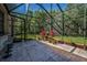 The screened patio features stone floors and plenty of space for decor, offering a serene outdoor retreat at 10808 Alico Pass, New Port Richey, FL 34655