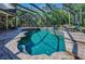 Beautiful in-ground pool with spa and lounging areas in a screened lanai, offering a private outdoor escape at 10808 Alico Pass, New Port Richey, FL 34655