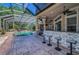 Relaxing outdoor screened-in pool area includes a bar, outdoor kitchen, and ample space for lounge chairs at 10808 Alico Pass, New Port Richey, FL 34655