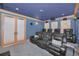 Home theater featuring tiered seating, a projector, and custom lighting at 10808 Alico Pass, New Port Richey, FL 34655