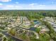 Aerial view of suburban homes with a pond and a nature preserve at 11254 Mollymawk Ct, New Port Richey, FL 34654