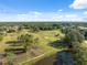 Beautiful aerial view of the golf course, showcasing its well-manicured greens, trees, and water features at 11254 Mollymawk Ct, New Port Richey, FL 34654