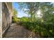 Private backyard featuring a paver patio, lush landscaping, and views of the surrounding greenery at 11254 Mollymawk Ct, New Port Richey, FL 34654