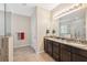 Modern bathroom featuring double vanities, granite countertops, and a glass enclosed shower at 11254 Mollymawk Ct, New Port Richey, FL 34654