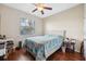 Bedroom with wood floors, ceiling fan and window at 11254 Mollymawk Ct, New Port Richey, FL 34654