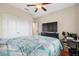Bedroom with wood floors, ceiling fan and window at 11254 Mollymawk Ct, New Port Richey, FL 34654