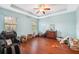 Bright bedroom features wood floors, ceiling fan, and large windows at 11254 Mollymawk Ct, New Port Richey, FL 34654