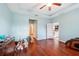Spacious bedroom with wood floors, a ceiling fan, and a tray ceiling at 11254 Mollymawk Ct, New Port Richey, FL 34654