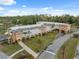 Aerial shot of a well-maintained community building with lush landscaping and ample parking at 11254 Mollymawk Ct, New Port Richey, FL 34654