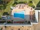 Overhead view of a community pool with ample lounge seating and a separate jacuzzi at 11254 Mollymawk Ct, New Port Richey, FL 34654