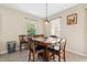 Cozy dining area featuring a wooden table with chairs and natural lighting from the windows at 11254 Mollymawk Ct, New Port Richey, FL 34654