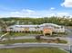 An attractive community center with a well-maintained lawn and palm trees in a suburban location at 11254 Mollymawk Ct, New Port Richey, FL 34654