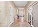 Inviting foyer with neutral tile flooring, white walls, and a view of the front door at 11254 Mollymawk Ct, New Port Richey, FL 34654