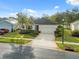 Charming single-story home featuring a well-maintained lawn, manicured landscaping, and a two-car garage at 11254 Mollymawk Ct, New Port Richey, FL 34654