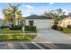 Front exterior of a well-maintained home featuring an attached garage and lovely landscaping at 11254 Mollymawk Ct, New Port Richey, FL 34654