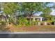 Charming single-story home with well-maintained landscaping, a covered porch, and a green lawn at 11254 Mollymawk Ct, New Port Richey, FL 34654
