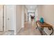 Bright hallway featuring tile flooring leading to the living area and bedrooms at 11254 Mollymawk Ct, New Port Richey, FL 34654
