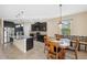 Open kitchen and dining area with granite countertops, stainless steel appliances, and dark wood cabinetry at 11254 Mollymawk Ct, New Port Richey, FL 34654
