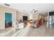 Spacious living room area featuring tile flooring, recessed lighting, and a comfortable seating arrangement at 11254 Mollymawk Ct, New Port Richey, FL 34654