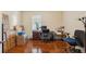 Bright office space with hardwood floors, large window, desk, office chair, and moving boxes at 11254 Mollymawk Ct, New Port Richey, FL 34654