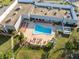 Overhead view of a community pool surrounded by lounge chairs and lush greenery at 11254 Mollymawk Ct, New Port Richey, FL 34654