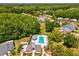 Aerial view of a community pool with surrounding trees and residential houses at 11536 Golden Rain Dr, New Port Richey, FL 34654