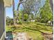 Expansive backyard with mature trees provides a serene setting at 11536 Golden Rain Dr, New Port Richey, FL 34654