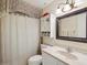 Bathroom vanity with a framed mirror, lighting, and a tub and shower combo at 11536 Golden Rain Dr, New Port Richey, FL 34654