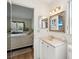 Bright bathroom with a framed mirror, stylish vanity, and convenient bedroom access at 11536 Golden Rain Dr, New Port Richey, FL 34654
