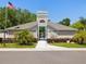 A community recreation entrance with manicured landscaping and mature trees at 11536 Golden Rain Dr, New Port Richey, FL 34654