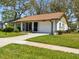 Charming home with attached garage, well-manicured lawn, and a welcoming entrance at 11536 Golden Rain Dr, New Port Richey, FL 34654