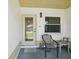 Cozy front porch with seating area, decorative door, and a welcoming ambiance at 11536 Golden Rain Dr, New Port Richey, FL 34654