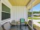 Relaxing front porch with comfortable seating and a view of the landscaped surroundings at 11536 Golden Rain Dr, New Port Richey, FL 34654