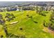 Aerial view of a well-manicured golf course with mature trees at 11536 Golden Rain Dr, New Port Richey, FL 34654