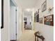 Inviting hallway with tile flooring, decorative wall art, and open access to living spaces at 11536 Golden Rain Dr, New Port Richey, FL 34654