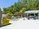 Relaxing hot tub next to gazebo with ample seating and lush landscaping at 11536 Golden Rain Dr, New Port Richey, FL 34654