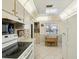 Kitchen has white appliances, ample cabinet space, and a cozy breakfast nook near the window at 11536 Golden Rain Dr, New Port Richey, FL 34654
