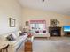 Comfortable living room with vaulted ceiling, fireplace, and bright natural light at 11536 Golden Rain Dr, New Port Richey, FL 34654