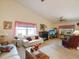 Bright living room offers large windows, ceiling fan, and fireplace for a cozy ambiance at 11536 Golden Rain Dr, New Port Richey, FL 34654