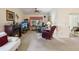 The inviting living room features a fireplace, neutral carpet, and large windows, perfect for relaxation at 11536 Golden Rain Dr, New Port Richey, FL 34654