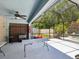 Large screened patio with ceiling fan next to community hot tub at 11536 Golden Rain Dr, New Port Richey, FL 34654